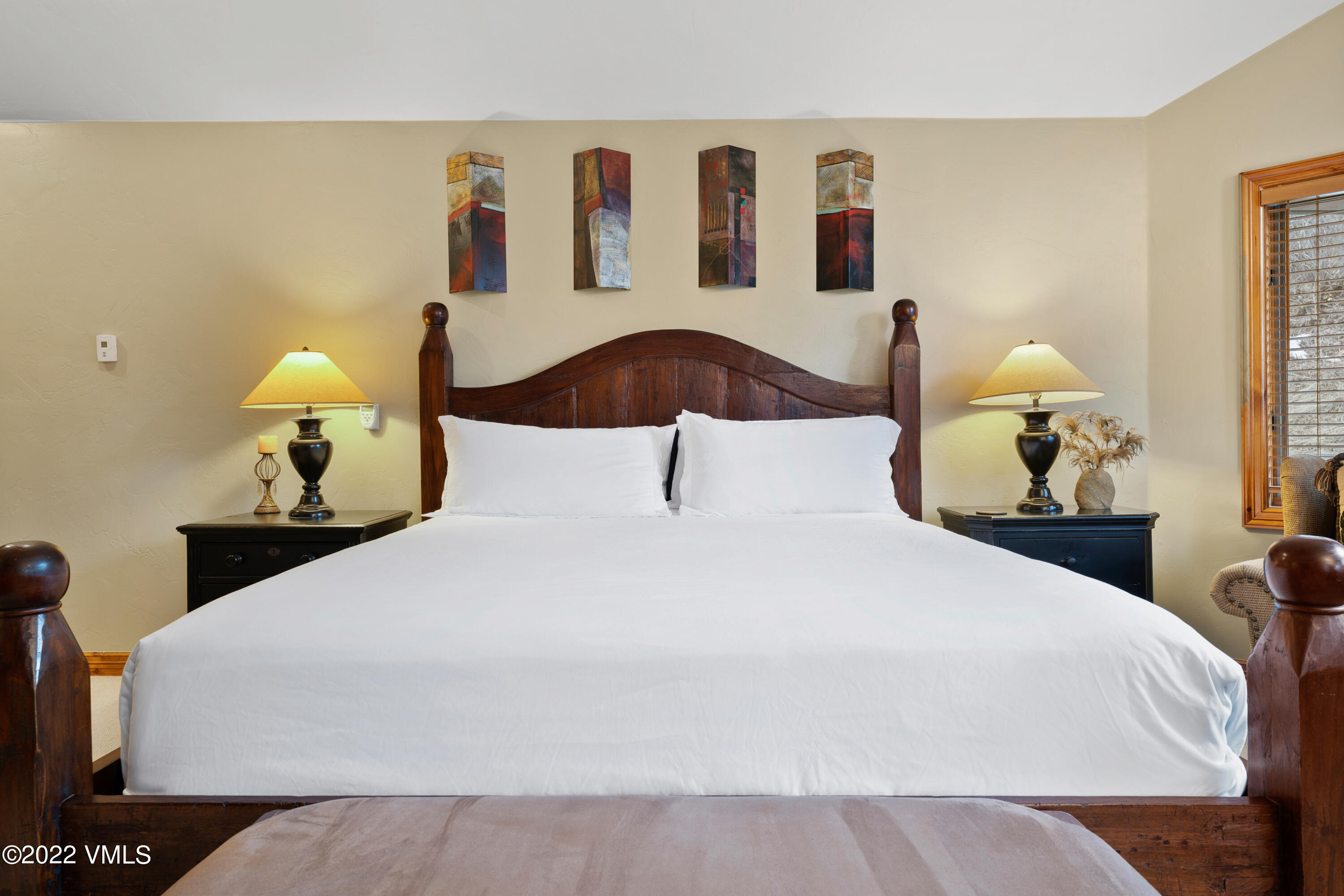 254 Arrowhead Drive, Unit B Edwards, CO 81632 - Photo 39 of 45 a bedroom with a bed and a painting on the wall