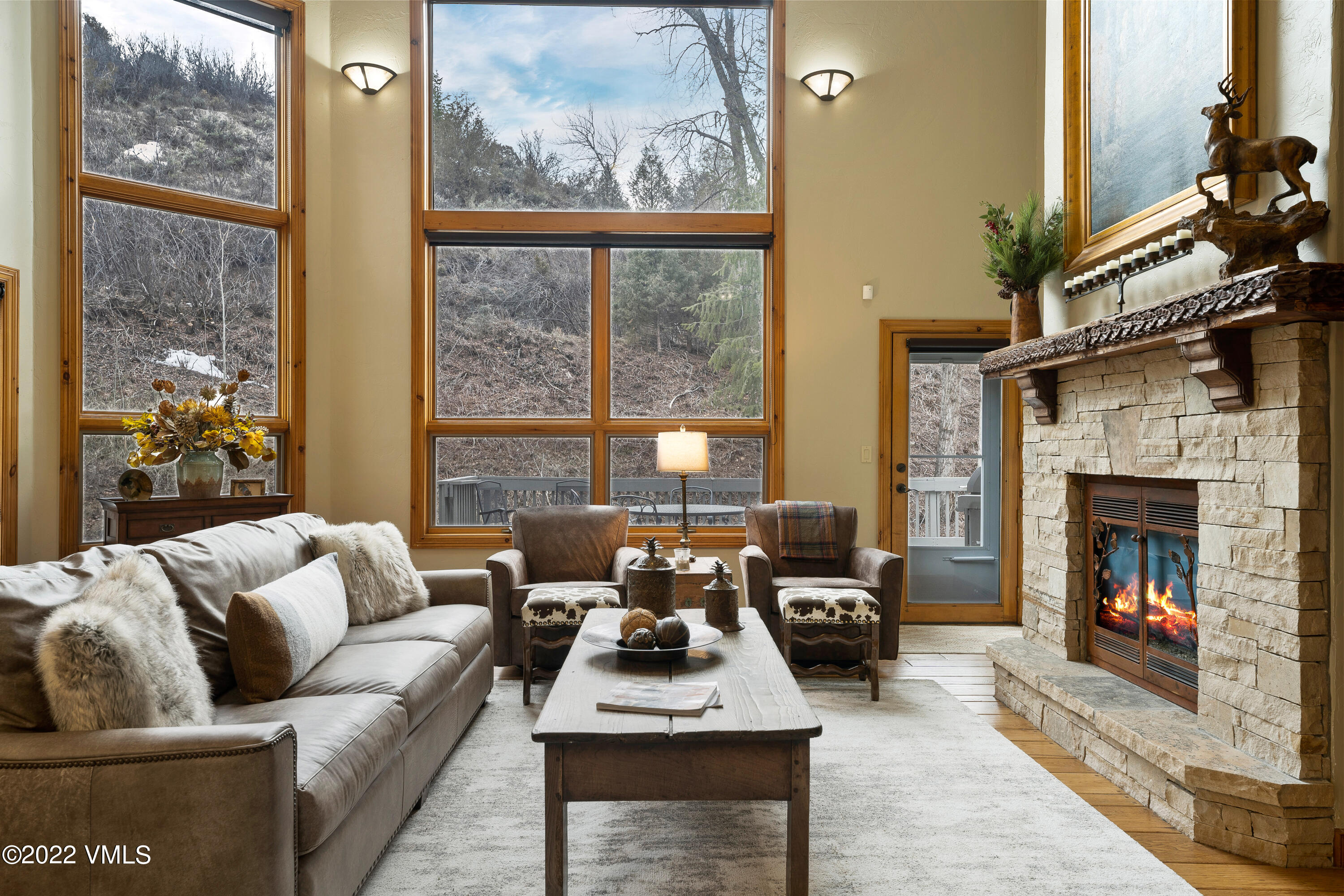 254 Arrowhead Drive, Unit B Edwards, CO 81632 - Photo 4 of 45 a living room with furniture a fireplace and a floor to ceiling window