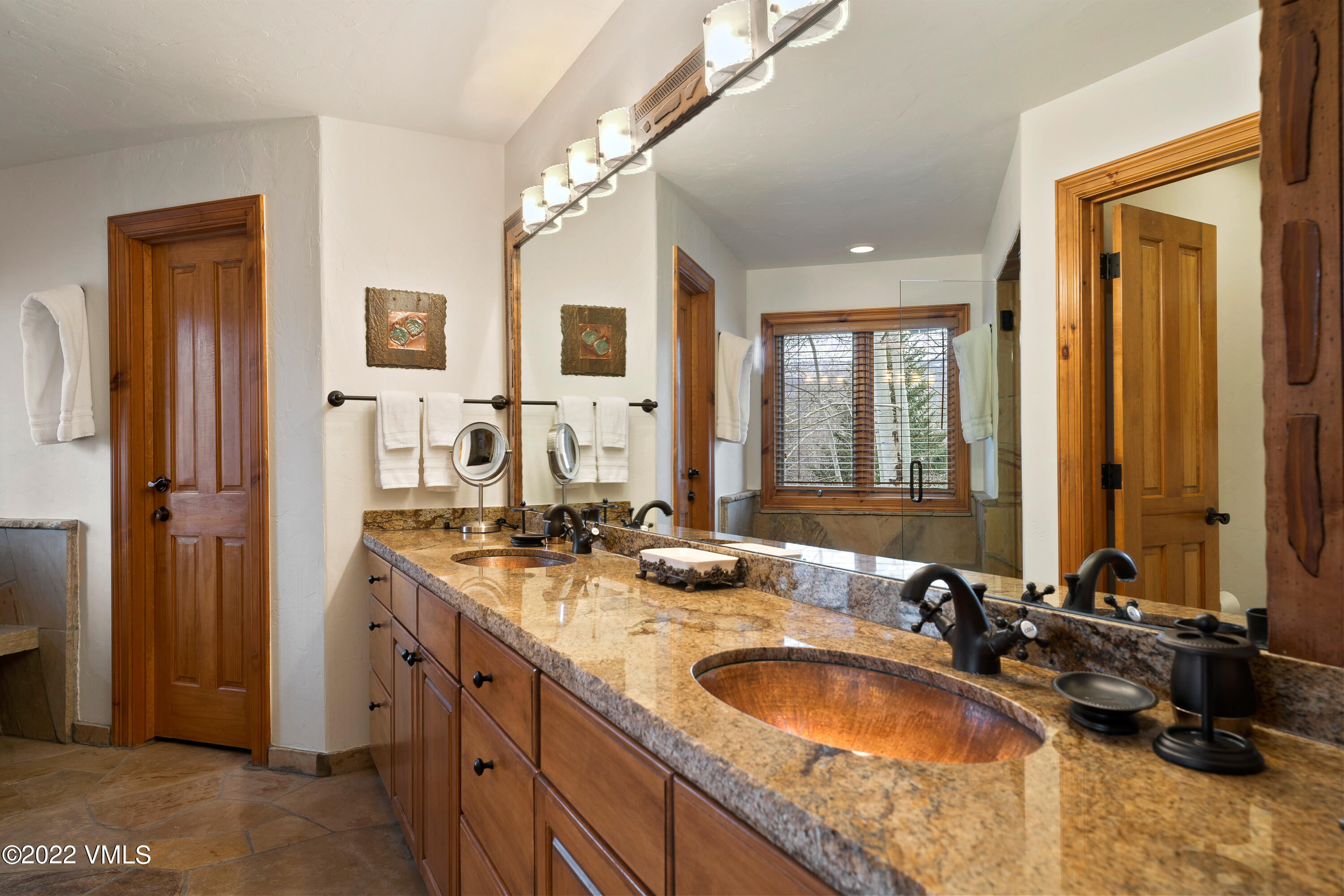 254 Arrowhead Drive, Unit B Edwards, CO 81632 - Photo 7 of 45 a bathroom with a granite countertop double vanity sink a mirror and a shower