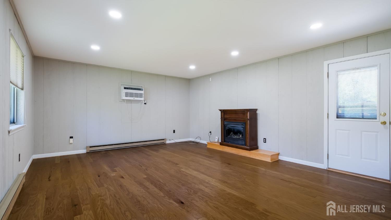 50 Sand Hills Road Kendall Park, NJ 08824 - Photo 7 of 27 a view of an empty room with wooden floor and a window