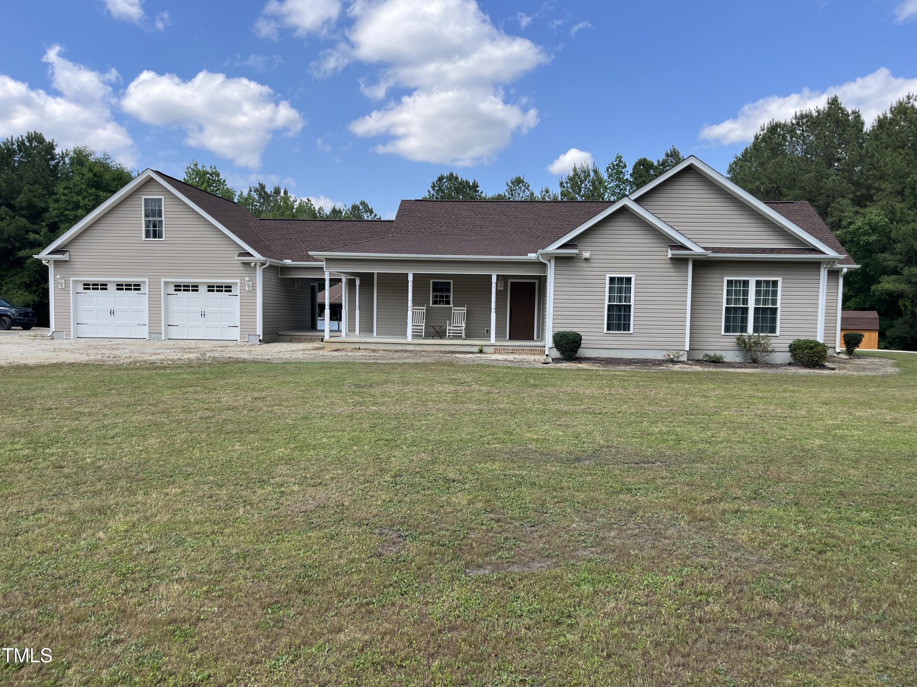 a front view of house with yard and green space