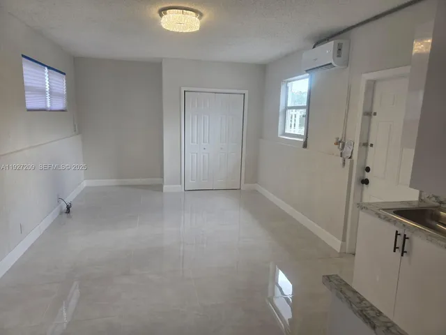 a kitchen with a refrigerator and a sink