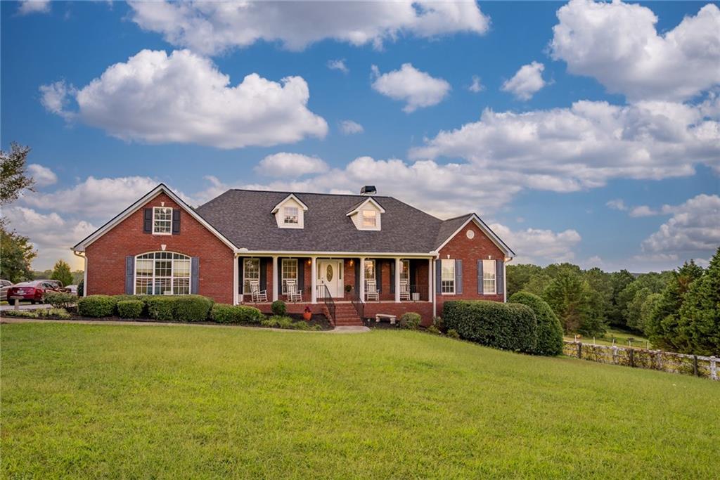 910 Carl Davis Road Northwest Monroe, GA 30656 - Photo 1 of 1 a front view of a house with a garden and yard