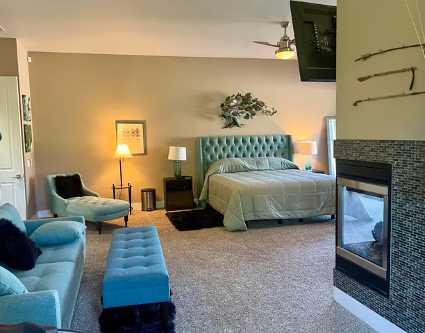 a living room with furniture a window and gym equipment