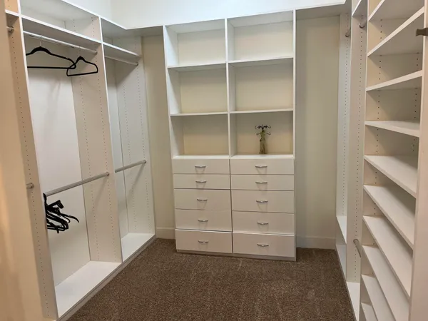 a bedroom with a bed a dresser and a flat screen tv