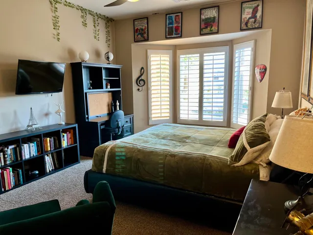 a bedroom with a bed and window