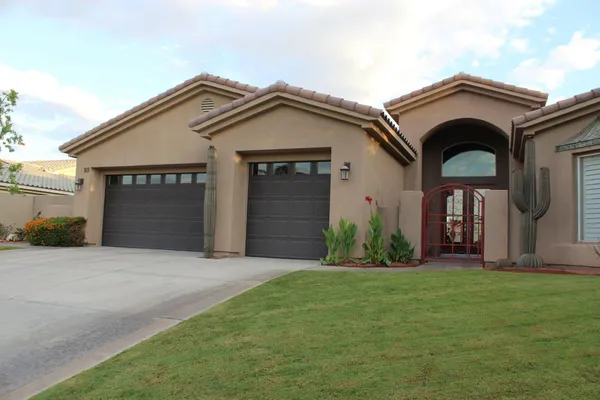 a front view of a house with a yard and garage