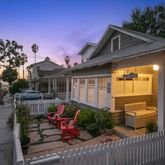 a front view of a house with outdoor seating