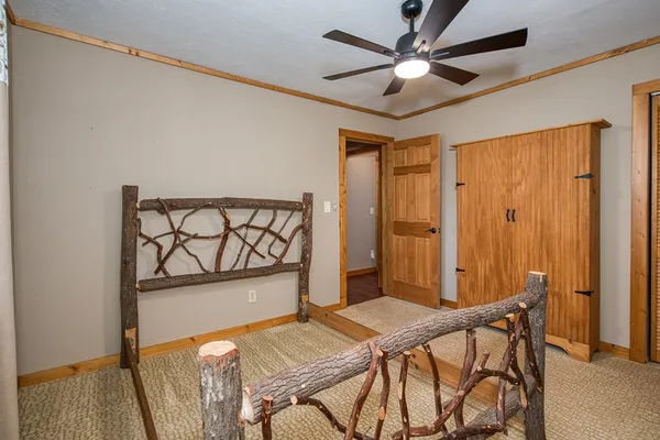 a view of empty room with kitchen and window