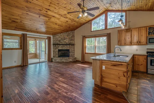 a kitchen with sink a window and cabinets