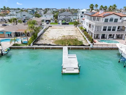 an aerial view of a house with swimming pool and view of a house