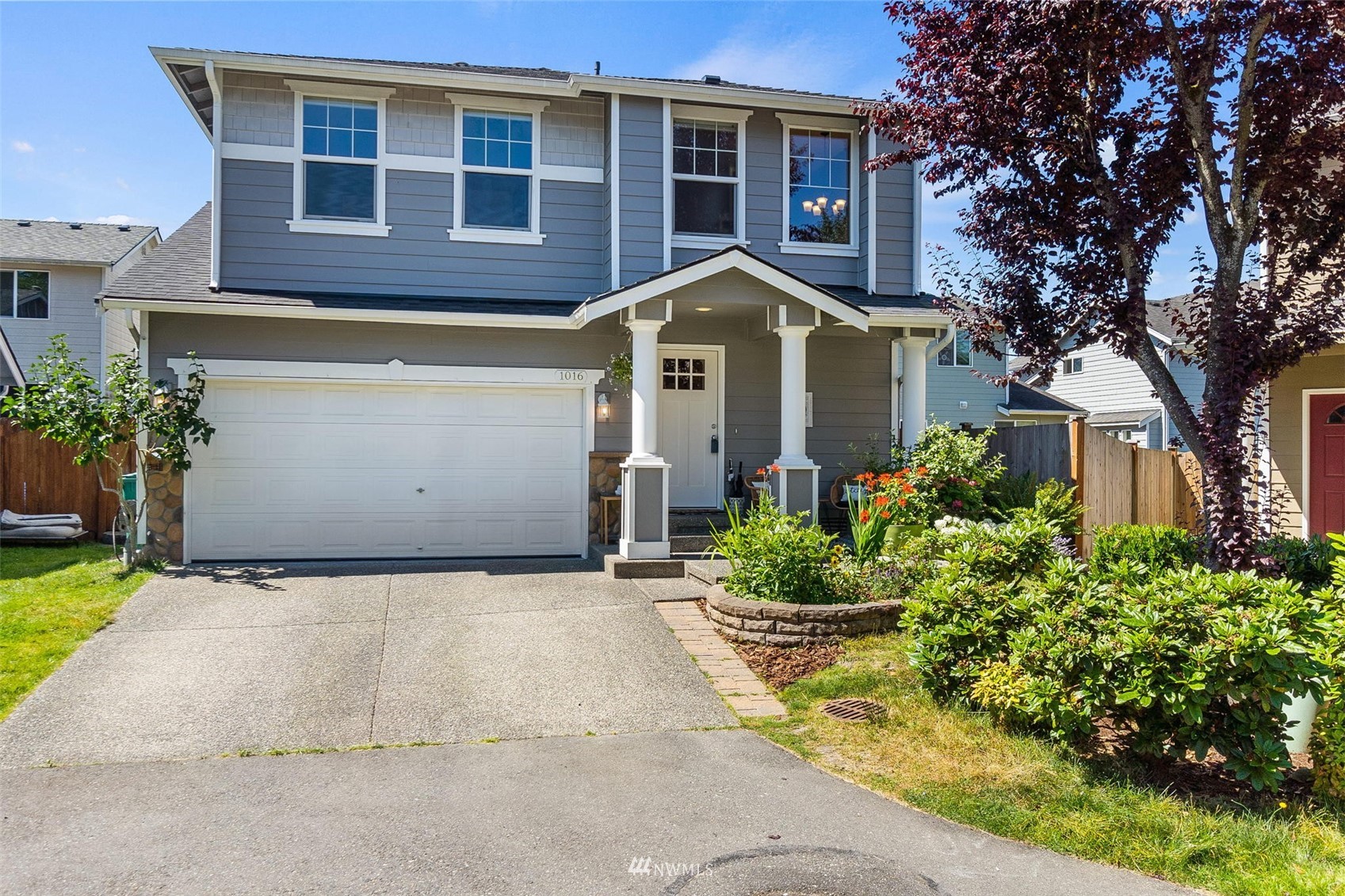 1016 186th Street Southeast Bothell, WA 98012 - Photo 1 of 26 a front view of a house with a garden