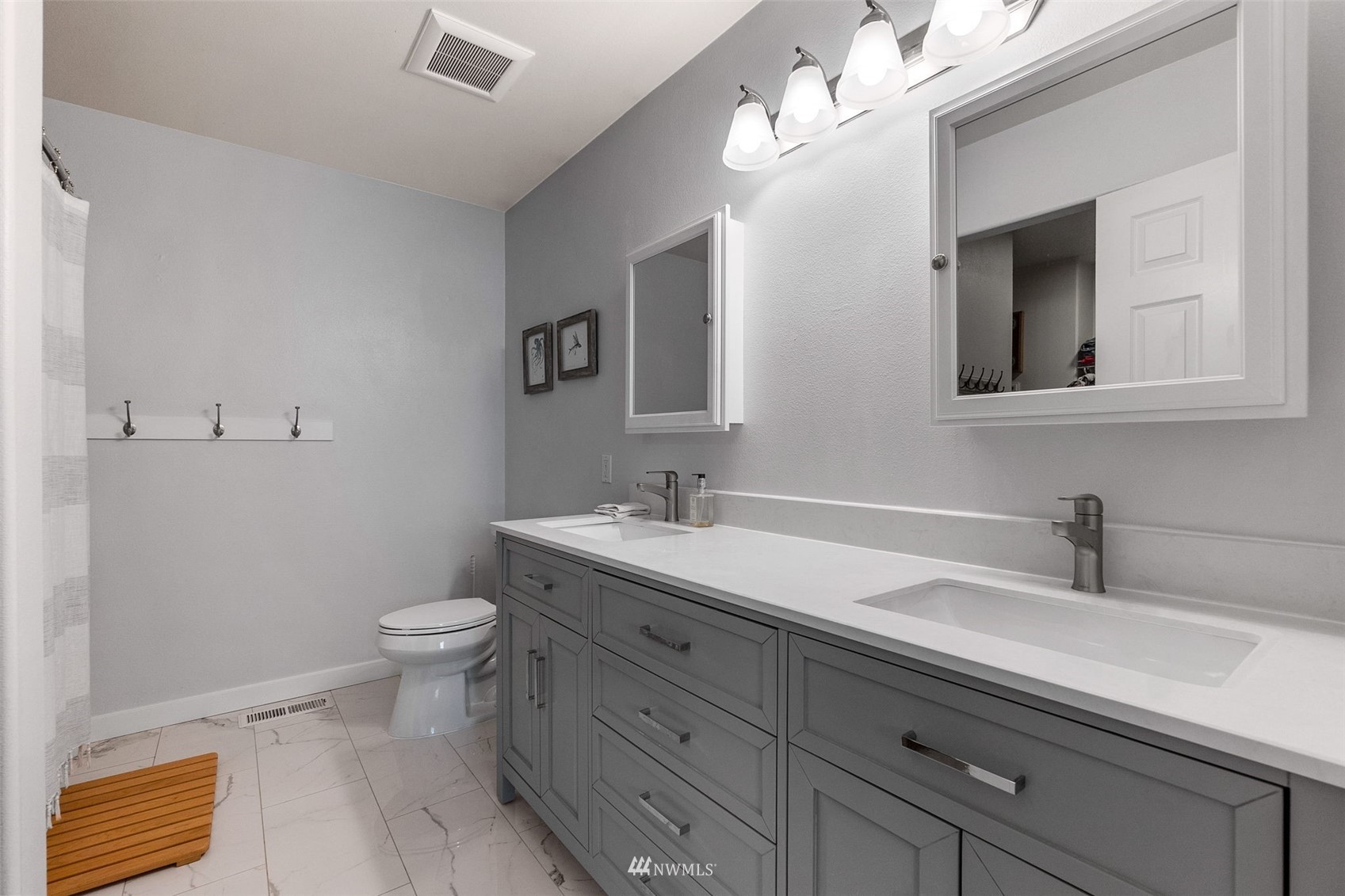 1016 186th Street Southeast Bothell, WA 98012 - Photo 18 of 26 a bathroom with a toilet sink and mirror