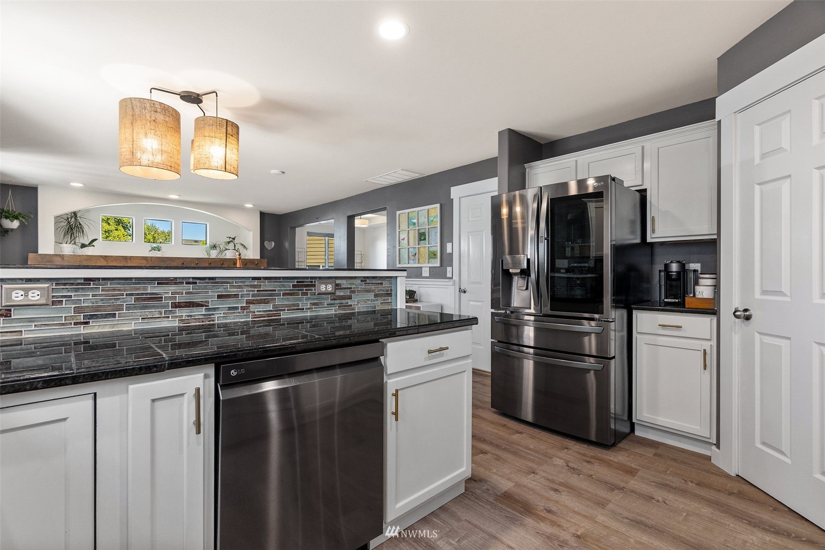 1016 186th Street Southeast Bothell, WA 98012 - Photo 7 of 26 a kitchen with stainless steel appliances granite countertop a refrigerator and a stove