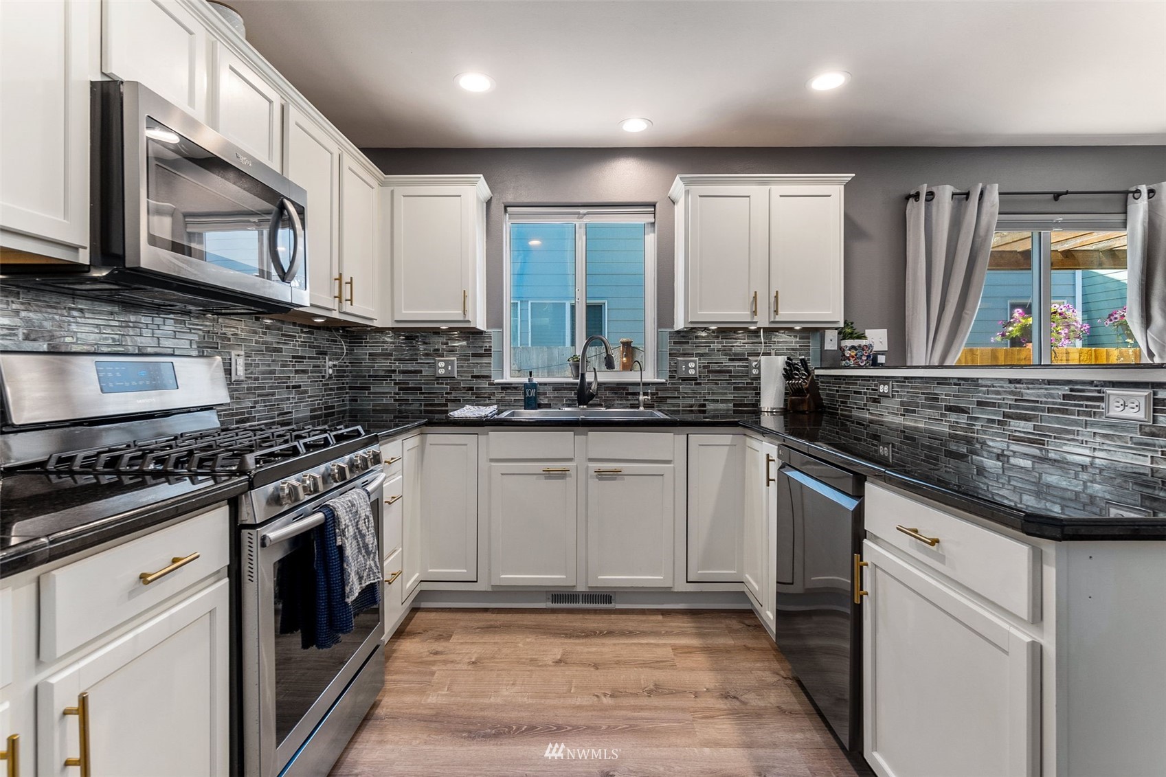 1016 186th Street Southeast Bothell, WA 98012 - Photo 8 of 26 a kitchen with stainless steel appliances granite countertop a stove a sink and a microwave