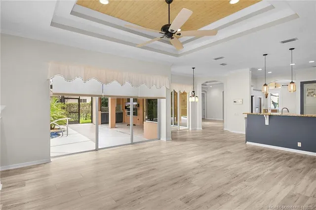 a view of a livingroom with a ceiling fan and window