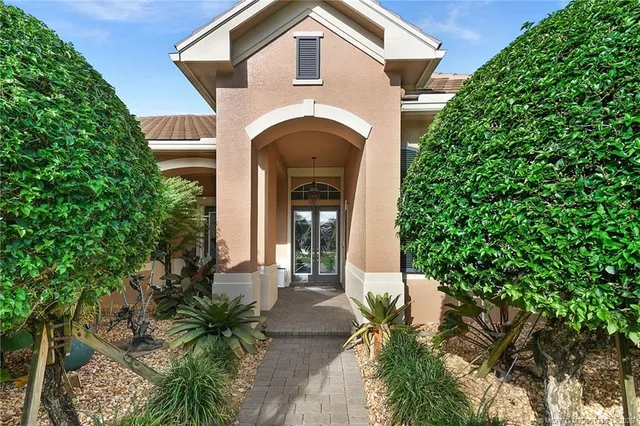 a kitchen with granite countertop a refrigerator sink and cabinets