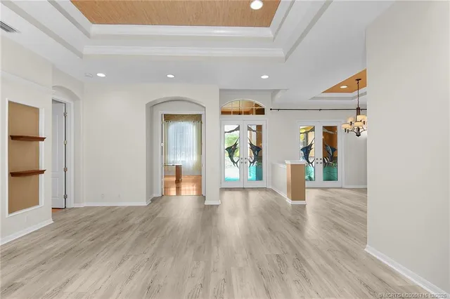 a view of a dining room with furniture and chandelier