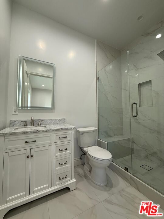 6717 Sunnyslope Avenue Van Nuys, CA 91401 - Photo 11 of 43 a bathroom with a shower sink vanity and toilet