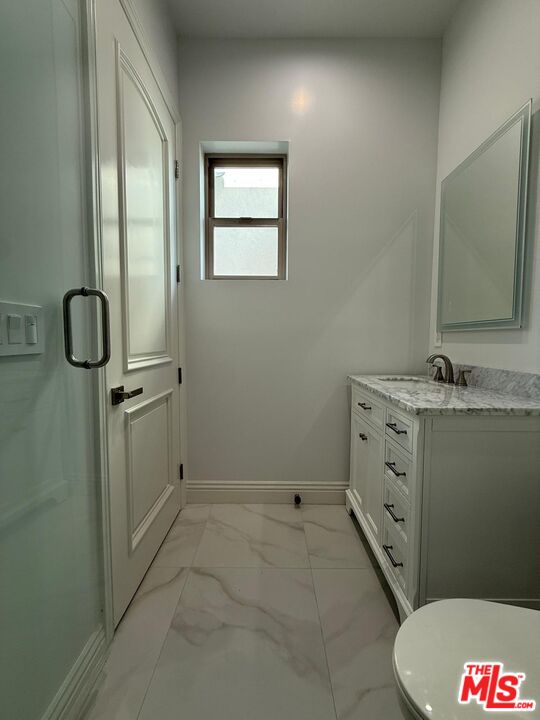 6717 Sunnyslope Avenue Van Nuys, CA 91401 - Photo 13 of 43 a bathroom with a sink and mirror