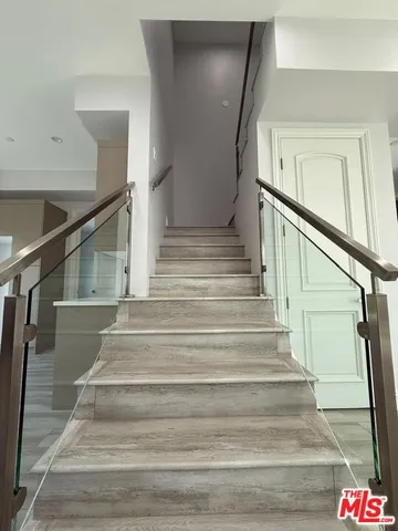 a view of wooden floor and windows in a room
