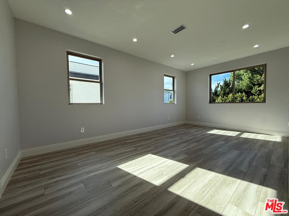 6717 Sunnyslope Avenue Van Nuys, CA 91401 - Photo 17 of 43 a view of wooden floor and windows in a room