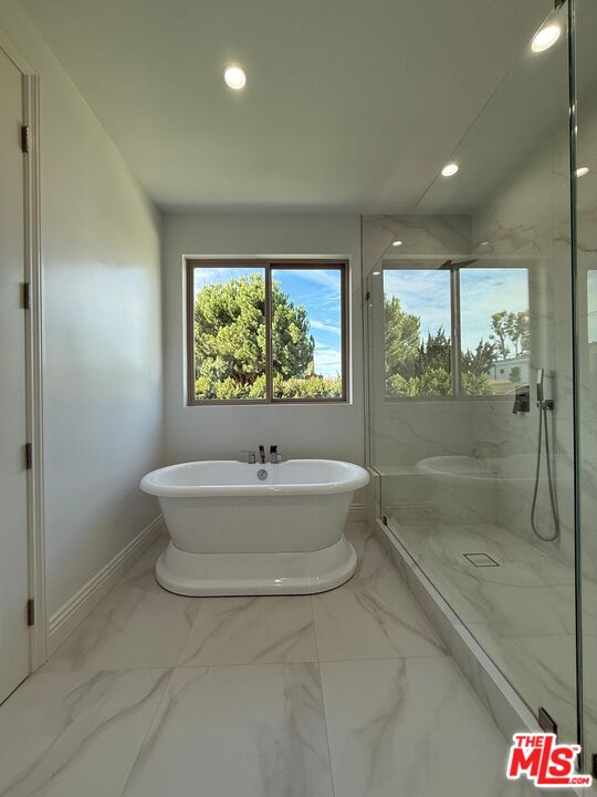 6717 Sunnyslope Avenue Van Nuys, CA 91401 - Photo 21 of 43 a bathroom with a bathtub and a shower