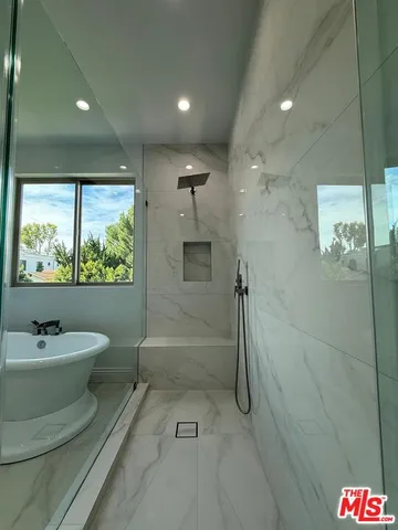 a bathroom with a double vanity sink toilet and shower