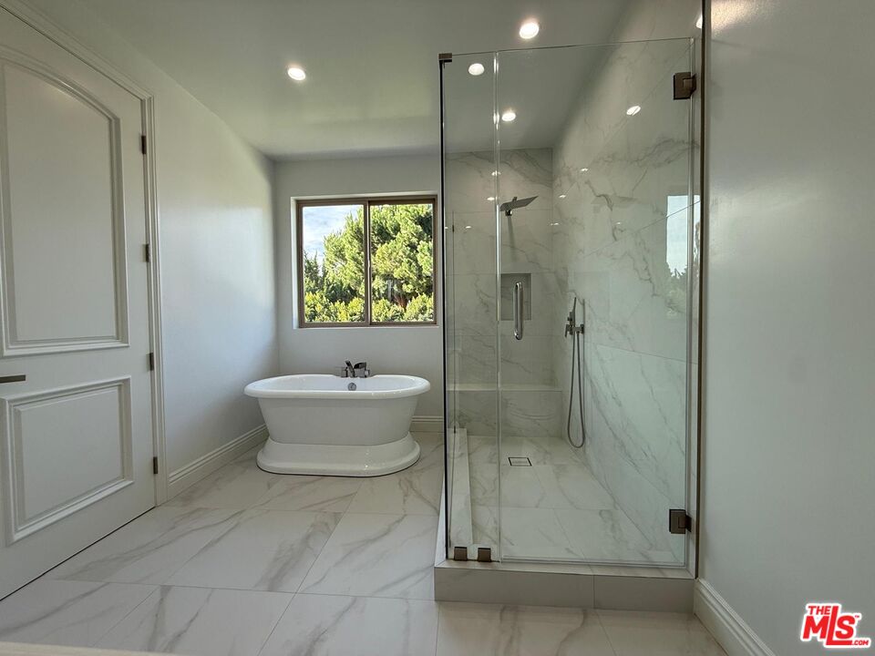 6717 Sunnyslope Avenue Van Nuys, CA 91401 - Photo 24 of 43 a bathroom with a bathtub and a shower