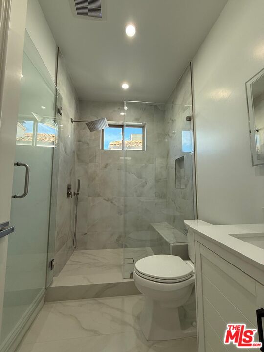 6717 Sunnyslope Avenue Van Nuys, CA 91401 - Photo 35 of 43 a bathroom with a toilet and a shower
