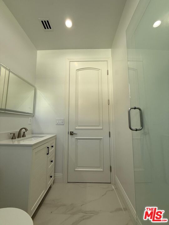 6717 Sunnyslope Avenue Van Nuys, CA 91401 - Photo 36 of 43 a bathroom with a sink and mirror