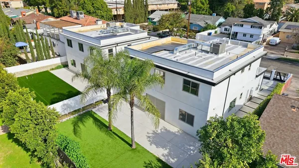 an aerial view of residential house with outdoor space and swimming pool