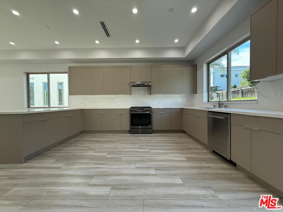 6717 Sunnyslope Avenue Van Nuys, CA 91401 - Photo 5 of 43 a view of kitchen with wooden floor and electronic appliances