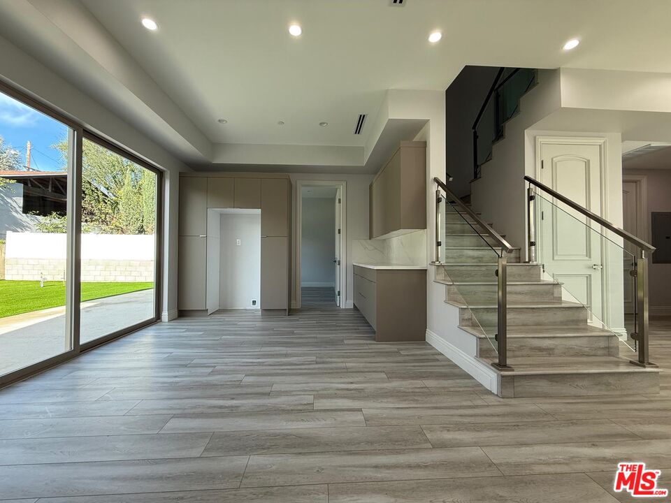 6717 Sunnyslope Avenue Van Nuys, CA 91401 - Photo 6 of 43 a view of an empty room with wooden floor and a window
