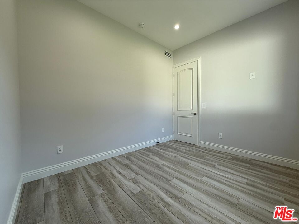 6717 Sunnyslope Avenue Van Nuys, CA 91401 - Photo 8 of 43 a view of room with wooden floor and window
