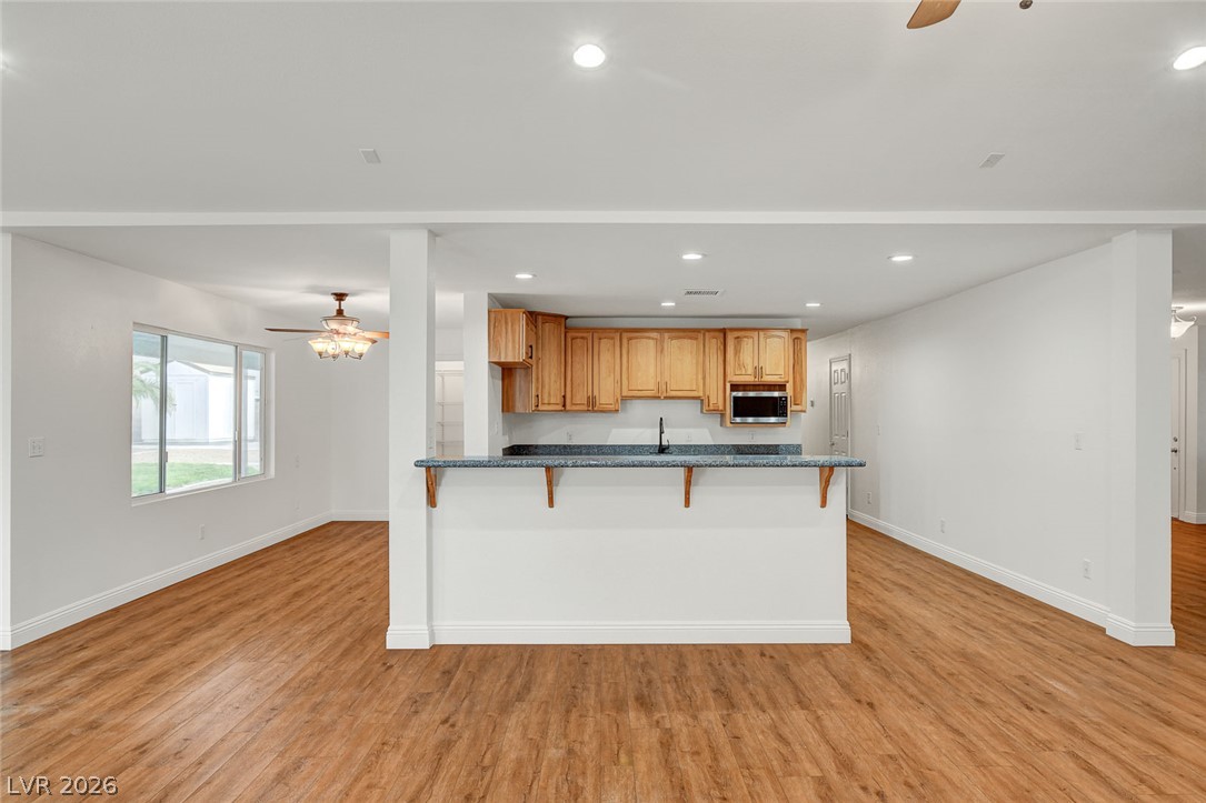 1810 Pinto Road Henderson, NV 89002 - Photo 53 of 53 An open floorplan offers seamless flow from the living area to the kitchen, featuring sleek counters and ample cabinet space.