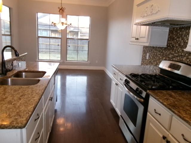 507 Falling Water Circle Bossier City, LA 71112 - Photo 7 of 15 a kitchen with granite countertop a stove and a sink