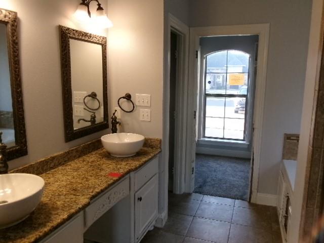 507 Falling Water Circle Bossier City, LA 71112 - Photo 9 of 15 a bathroom with a granite countertop sink and a mirror