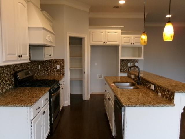 507 Falling Water Circle Bossier City, LA 71112 - Photo 10 of 15 a kitchen with a sink a stove and cabinets