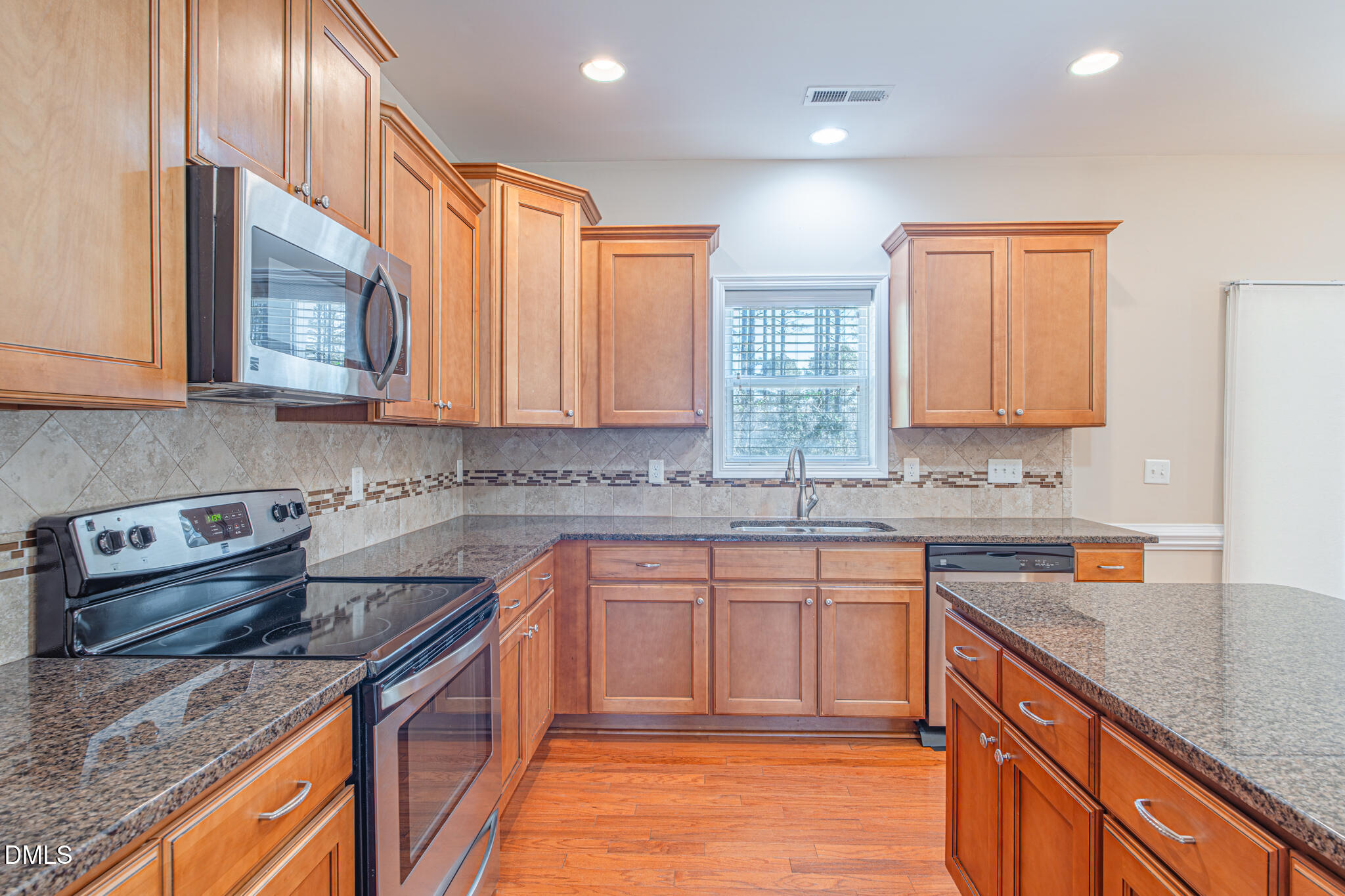 403 Rolling Pines Drive Spring Lake, NC 28390 - Photo 11 of 56 a kitchen with stainless steel appliances granite countertop a sink stove and cabinets