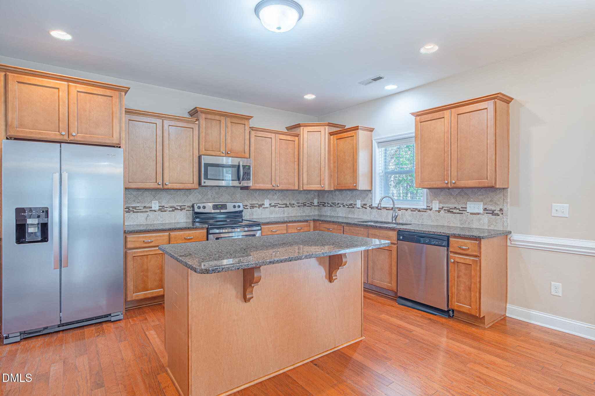 403 Rolling Pines Drive Spring Lake, NC 28390 - Photo 12 of 56 a kitchen with stainless steel appliances granite countertop a sink stove and refrigerator