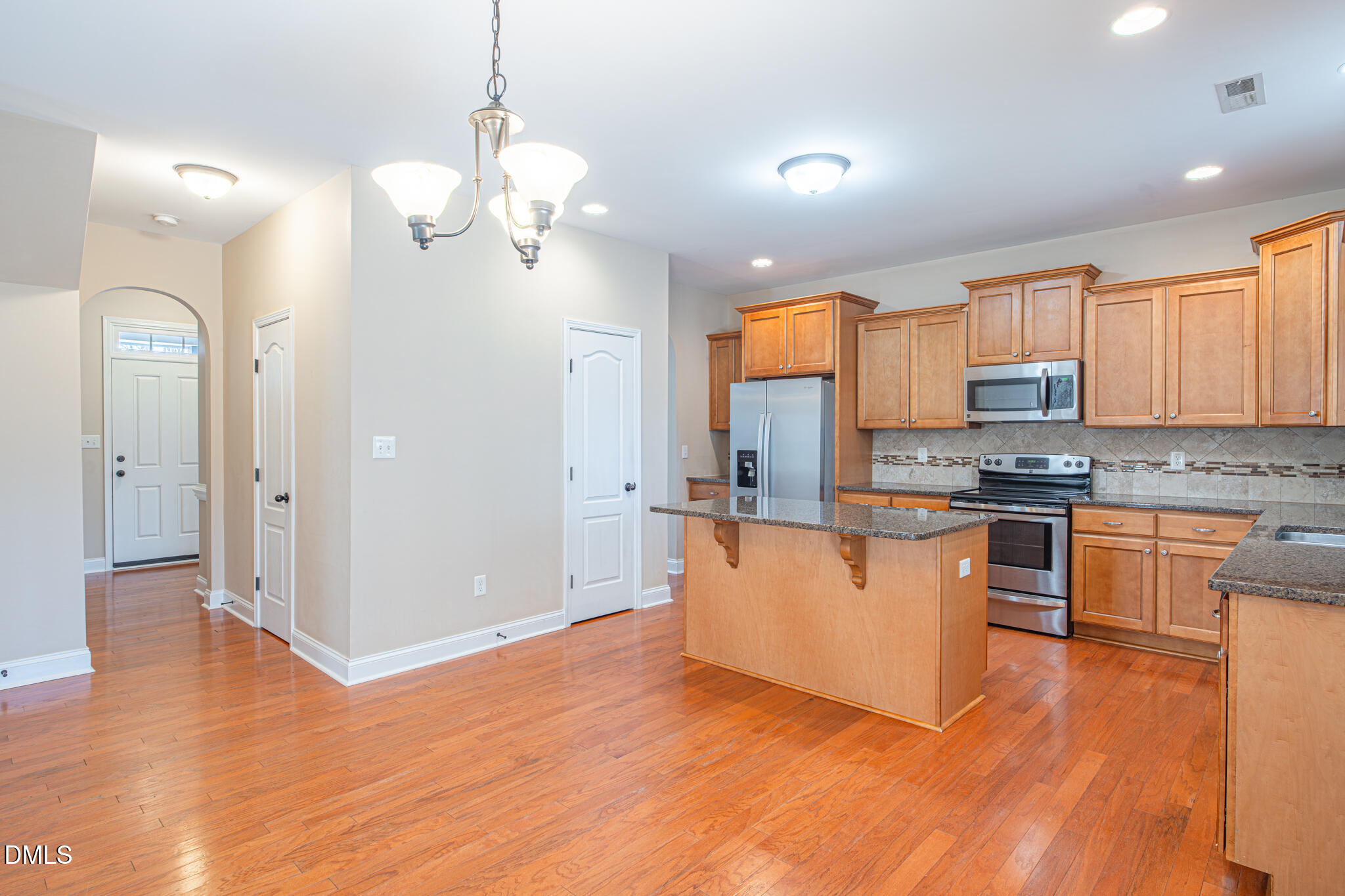 403 Rolling Pines Drive Spring Lake, NC 28390 - Photo 14 of 56 a kitchen with stainless steel appliances granite countertop a refrigerator a stove top oven and a wooden floors