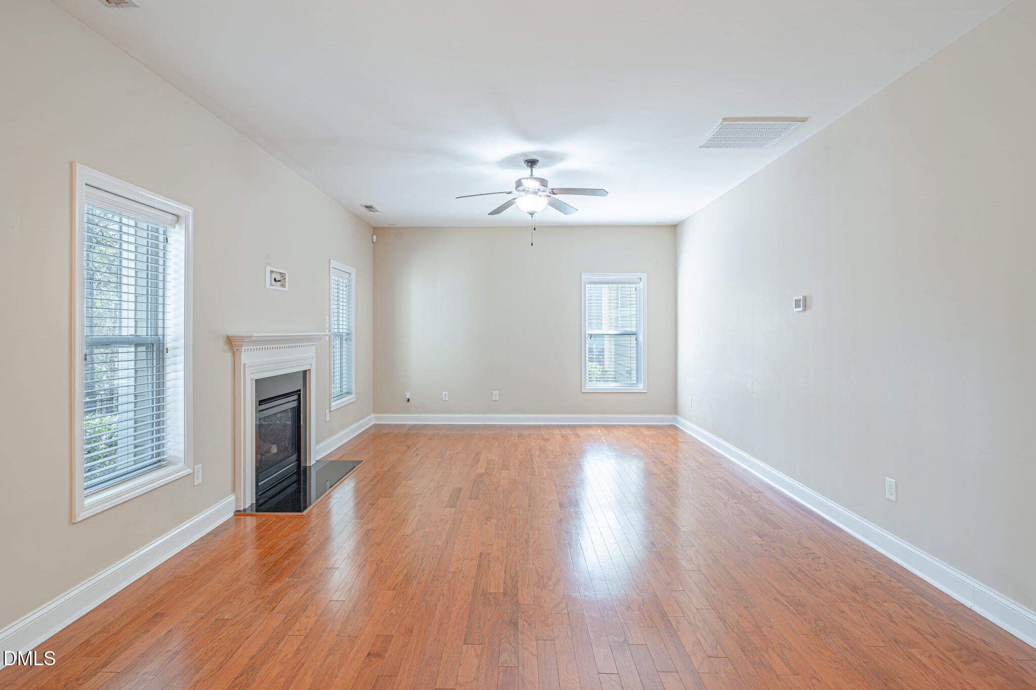 403 Rolling Pines Drive Spring Lake, NC 28390 - Photo 16 of 56 wooden floor in an empty room with a window