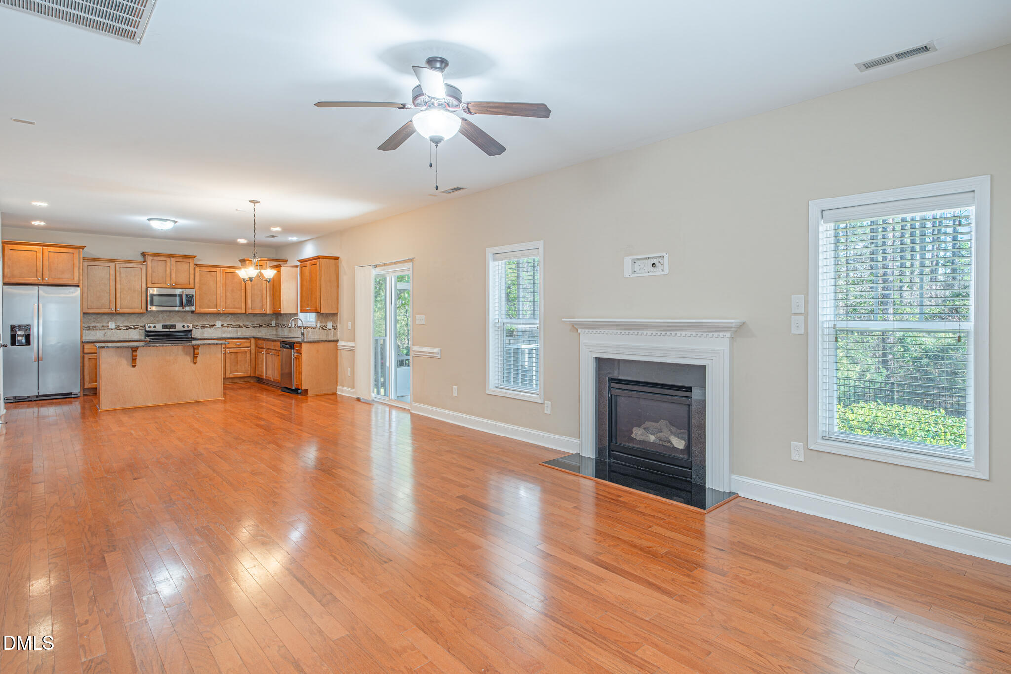 403 Rolling Pines Drive Spring Lake, NC 28390 - Photo 18 of 56 an empty room with wooden floor a fireplace and a window