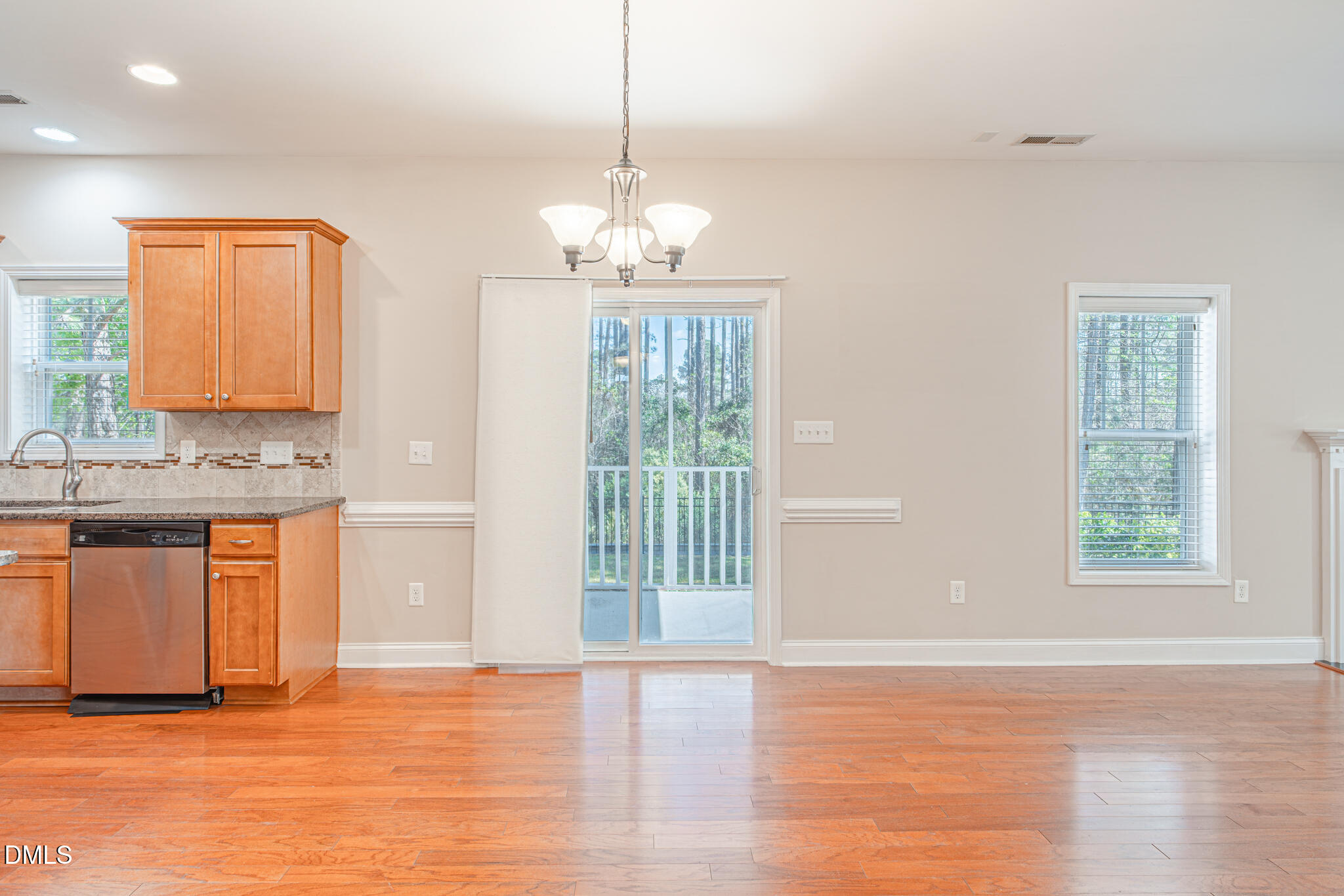 403 Rolling Pines Drive Spring Lake, NC 28390 - Photo 20 of 56 a view of a kitchen with granite countertop a stove top oven a sink and dishwasher with wooden floor