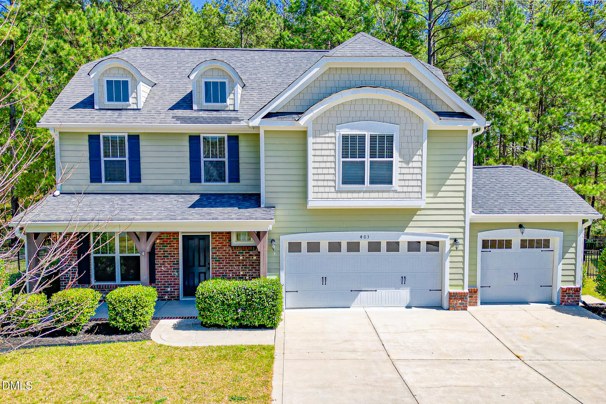 403 Rolling Pines Drive Spring Lake, NC 28390 - Photo 3 of 56 a front view of a house with garden