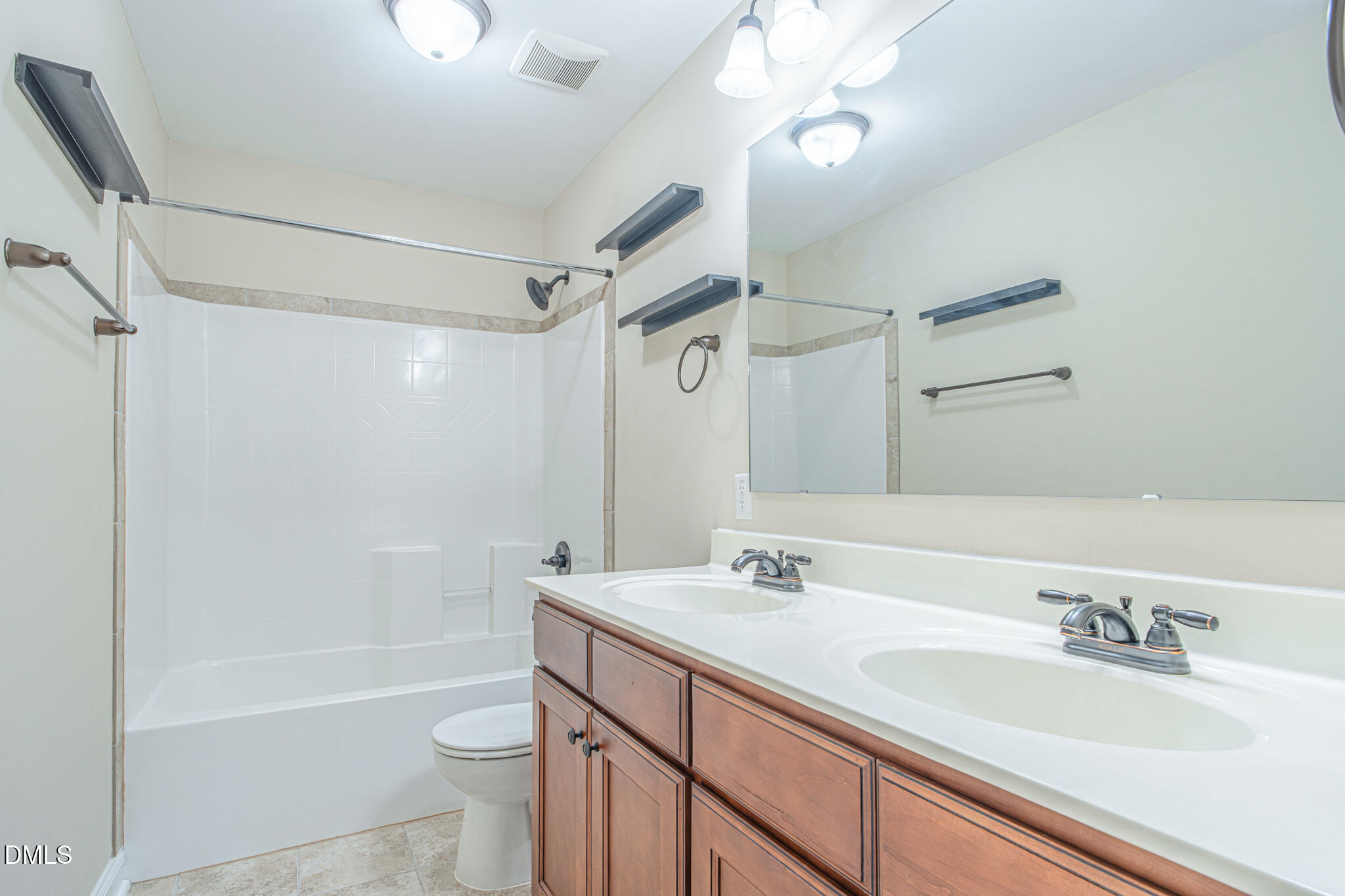 403 Rolling Pines Drive Spring Lake, NC 28390 - Photo 35 of 56 a bathroom with a sink a toilet a mirror a bathtub and shower