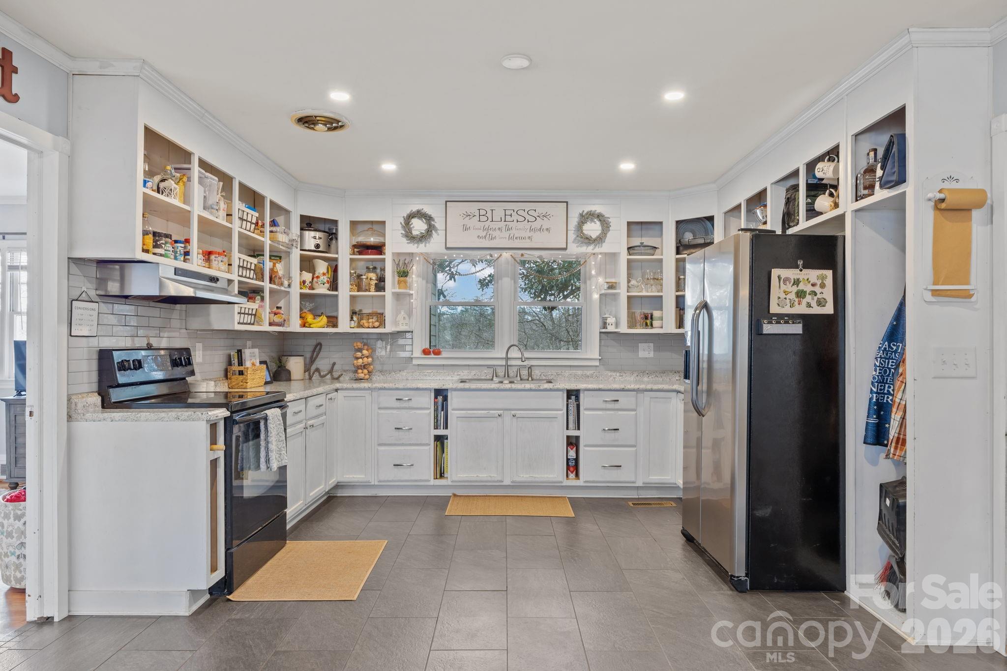 275 Tanner Street Rutherfordton, NC 28139 - Photo 23 of 44 a kitchen with stainless steel appliances granite countertop a refrigerator and a stove top oven