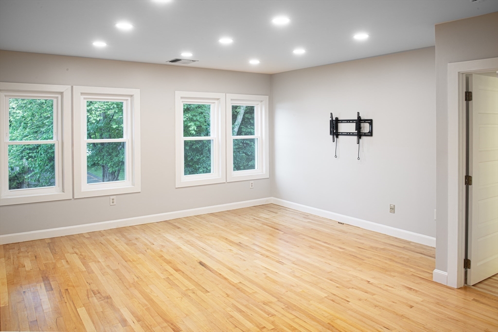 500 West Street, Unit 6 Amherst, MA 01002 - Photo 4 of 20 a view of an empty room with wooden floor and a window