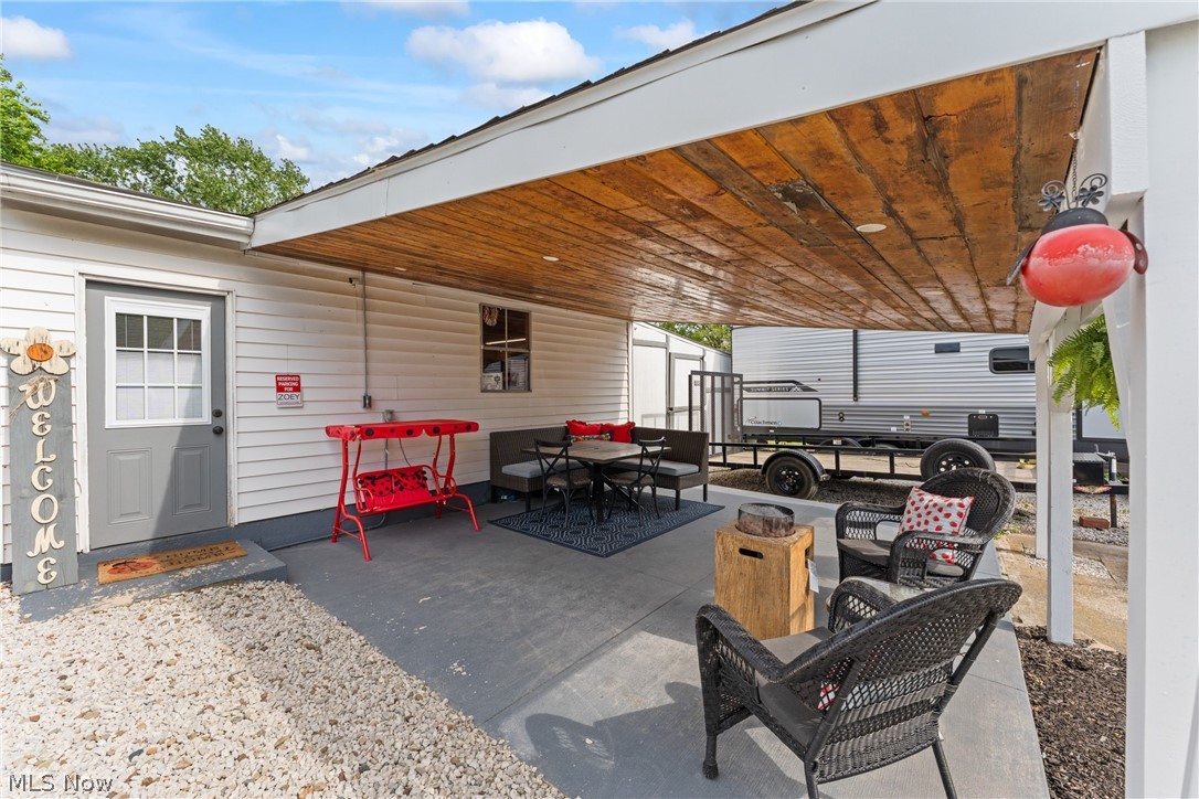 258 Randolph Road Mogadore, OH 44260 - Photo 32 of 49 Covered outdoor patio area featuring a natural wood ceiling, concrete flooring, and white siding